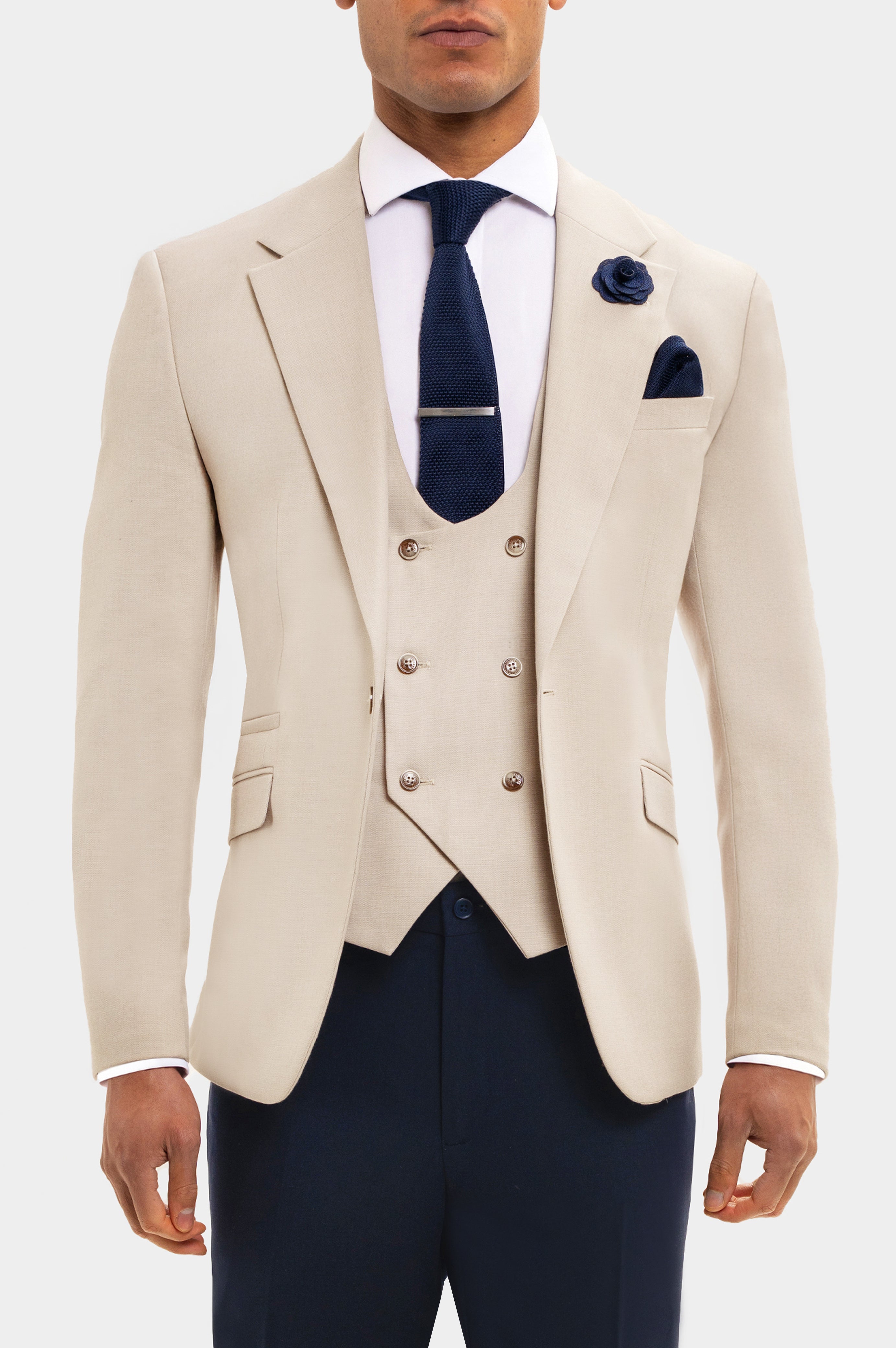 Beige suit jacket, navy vest, and pants with a white shirt and blue tie on a white background